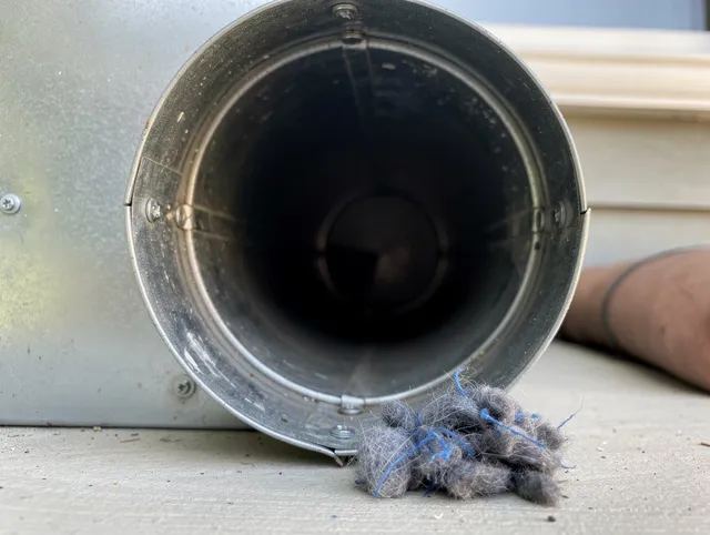 Stow Dryer Vent Cleaning technician using specialized equipment to clear severe dryer vent blockage in Stow